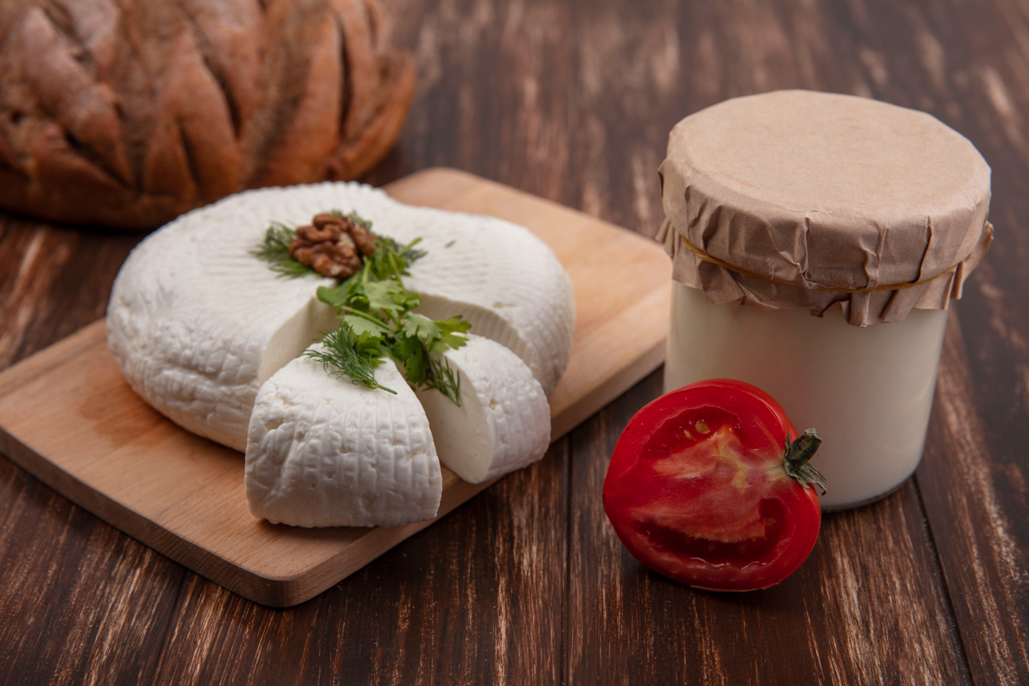 Fromage frais aux herbes, noix et tomate sur planche rustique chez-basta à muret